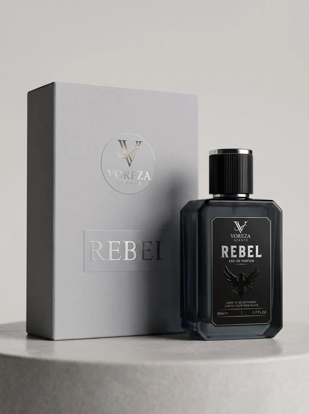 A dark glass bottle of VORZA Rebel cologne stands in front of its light gray packaging box on a round pedestal against a neutral gray background.